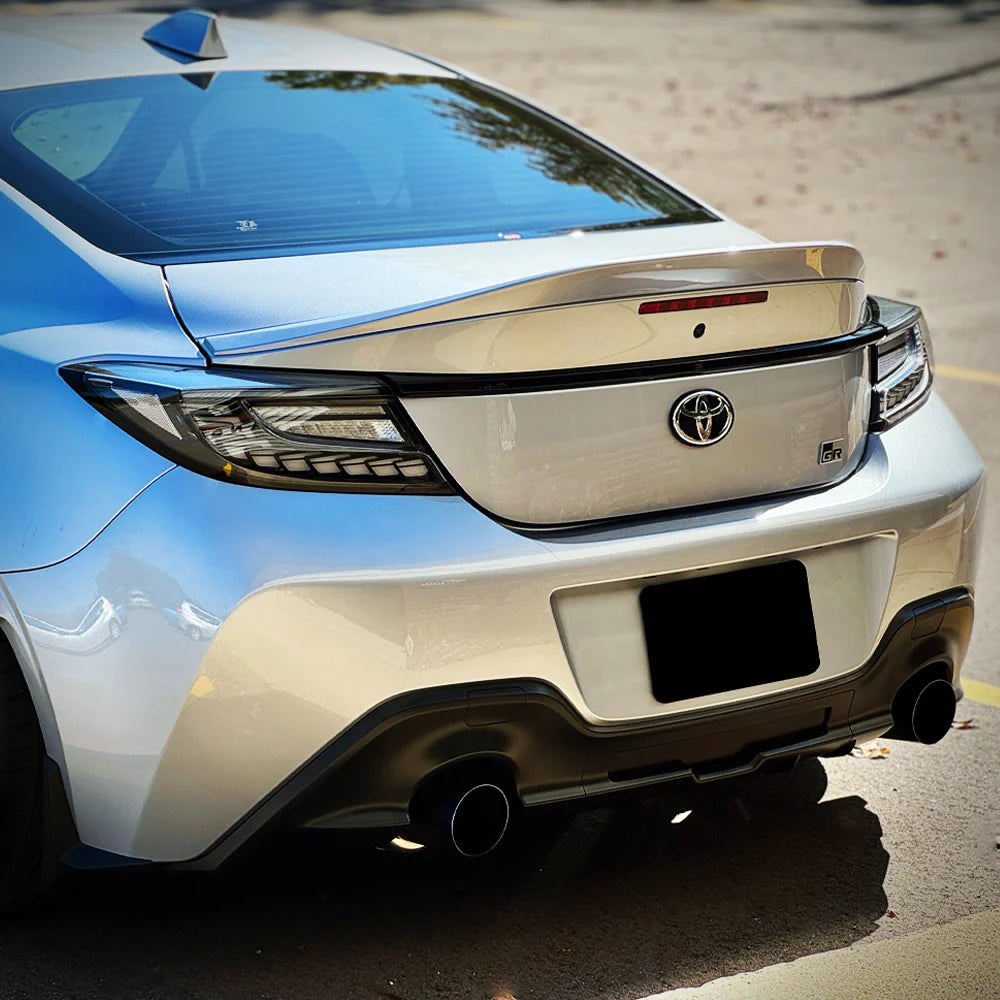 clear Lens Full LED Dragon Scale Taillights for 2021-2024 Toyota GR86 and Subaru BRZ, featuring a unique dragon scale design with bright red brake lights, dynamic amber sequential turn signals, and full LED DRLs for enhanced visibility and a modern, stylish appearance.