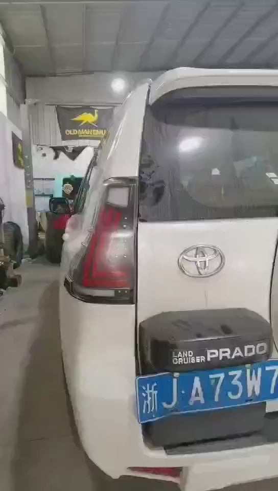 Smoked LED Taillights for 2010-2021 Toyota Prado, featuring sleek design with dynamic startup animation, bright red brake lights, amber sequential turn signals, and double white reverse lights, enhancing both the vehicle's modern aesthetic and safety