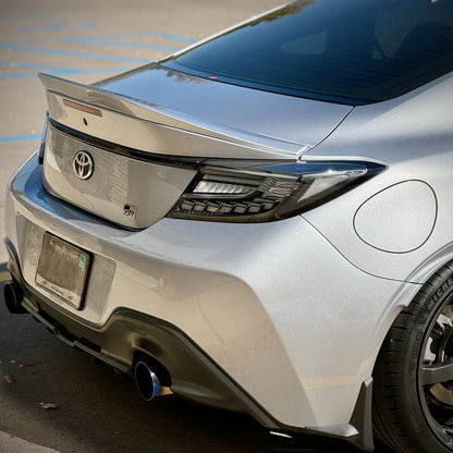 clear Lens Full LED Dragon Scale Taillights for 2021-2024 Toyota GR86 and Subaru BRZ, featuring a unique dragon scale design with bright red brake lights, dynamic amber sequential turn signals, and full LED DRLs for enhanced visibility and a modern, stylish appearance.